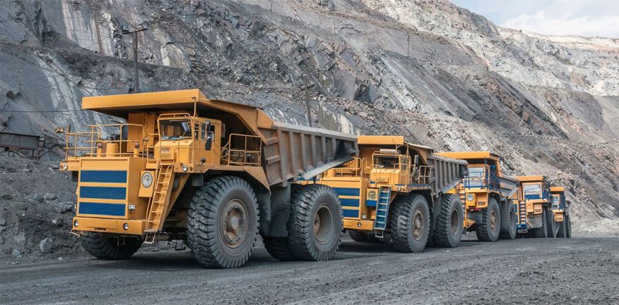 Fleet of mining dump trucks at quarry